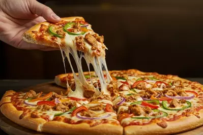 person grabbing piece of pizza