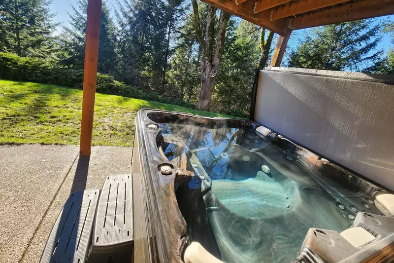 Enjoy soaking in the hot tub taking in the serene setting.