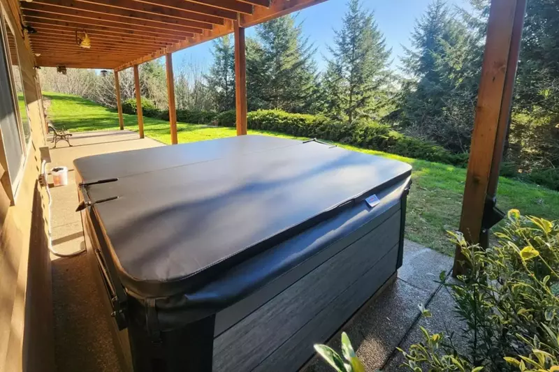 Rain or shine, enjoy unwinding in the hot tub.