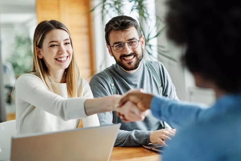 couple shaking hands with property manager