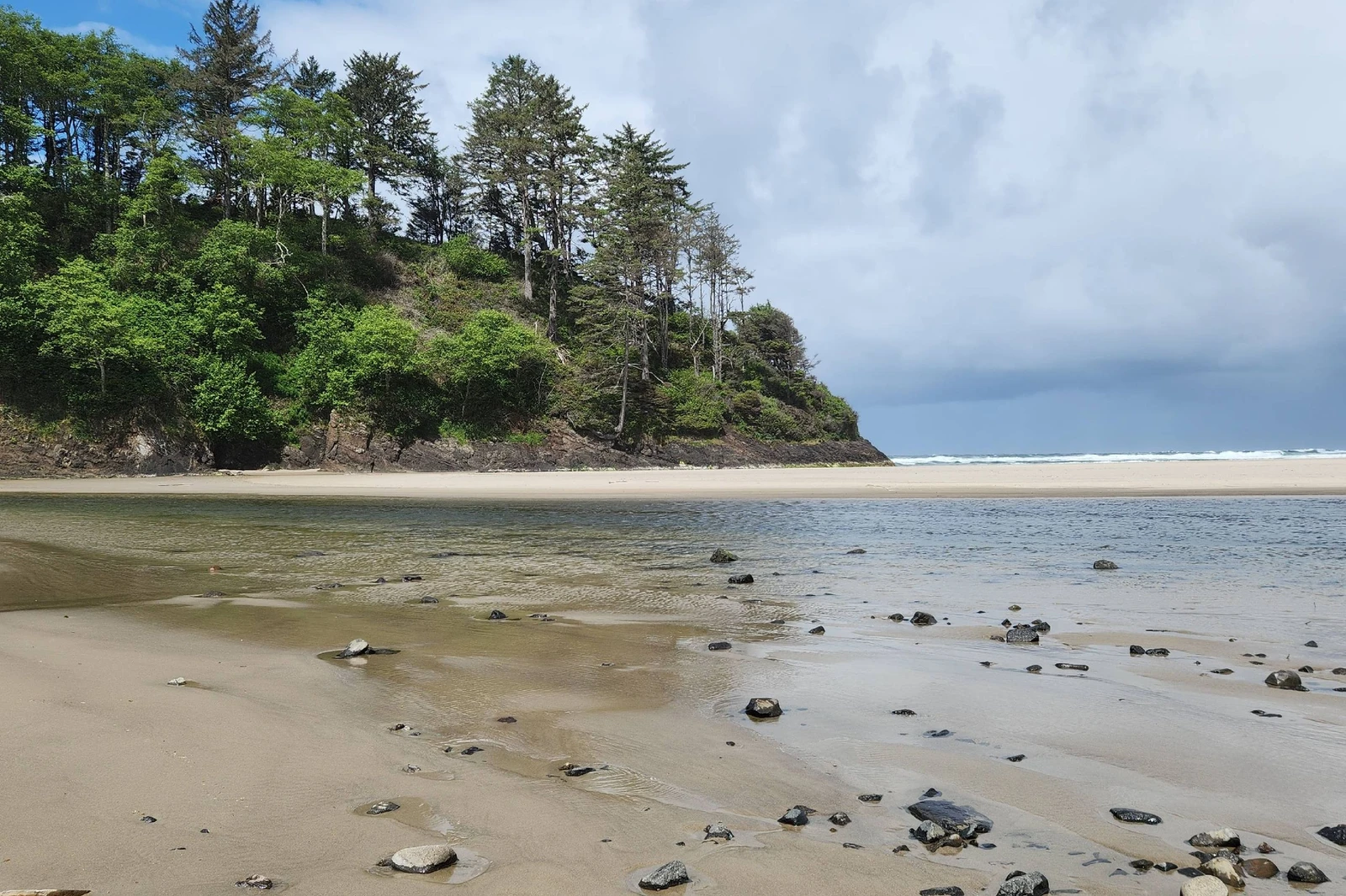 Where the creek meets the Pacific — a peaceful walk from forested shoreline to wide sandy beach in Neskowin.