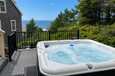 Relax in the hot tub while taking in sweeping Pacific views.
