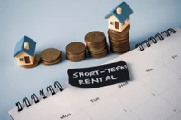 model of short term rental houses with coins